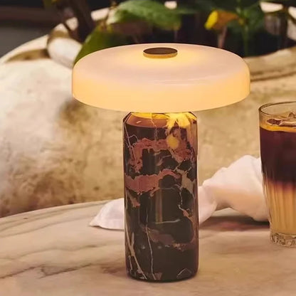 Marble-patterned bottle with a lamp on a table with a blurred background