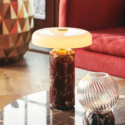 Table lamp with marble base on a round table in a living room setting